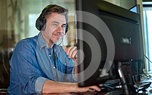 Casual man working with computer in office