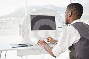 Casual man working at desk with computer and digitizer