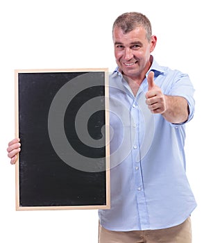 Casual middle aged man holds blackboard