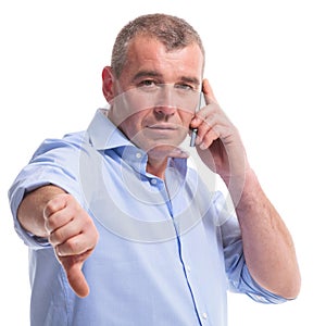 Casual middle aged man thumb down on the phone