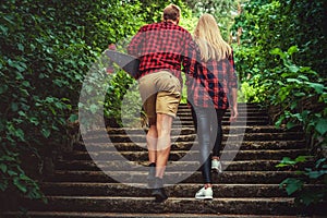 Casual moder young skateboarders couple posing on footway.