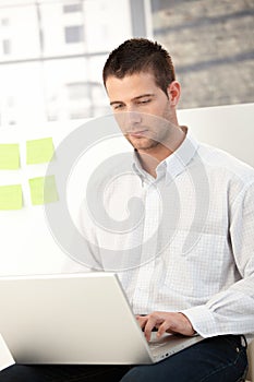 Casual office worker using laptop