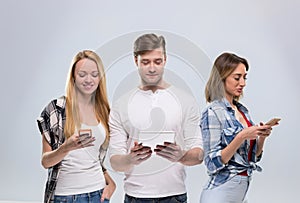 Casual People Group, Young Man Two Woman Happy Smile Using Cell Smart Phone Network Communication