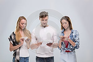 Casual People Group, Young Man Two Woman Happy Smile Using Cell Smart Phone Network Communication