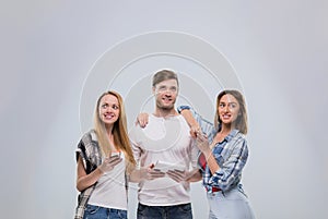 Casual People Group, Young Man Two Woman Happy Smile Using Cell Smart Phone Network Communication Looking To Copy Space
