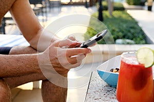 Casual Poolside Break with Smartphone and Mocktail