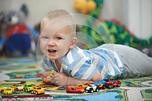 Casual portrait of a toddler playing with toy cars