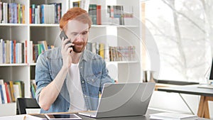 Casual Redhead Man Talking on Phone, Negotiating Contract