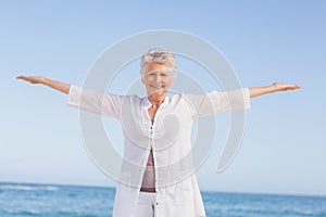 Casual senior woman with arms outstretched