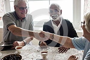 Casual seniors shaking hands together photo