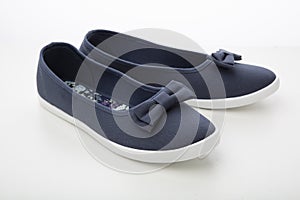 casual shoes, summer women`s sneakers with bows made of fabric isolated