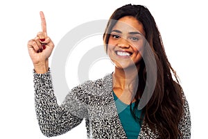Casual smiling girl pointing upwards