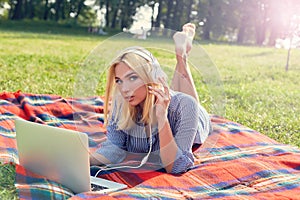 Casual student listening to music on the computer while studying