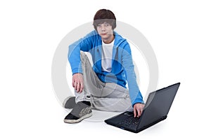 Casual teenager boy sitting on the floor