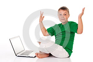 Casual teenager in bright green t-shirt with laptop over white background. Use or harm of computer games, children`s leisure and