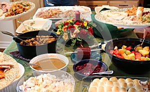 Casual Thanksgiving Feast on Table with Plates Being Filled photo