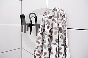 Casual towel is hanging on a unusual hook chair shaped