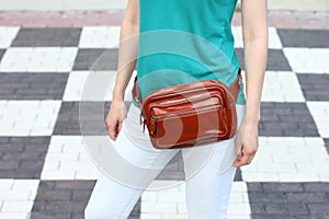 Casual weared women with big leather weist bag on black and whit