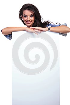 Casual woman behind a blank board