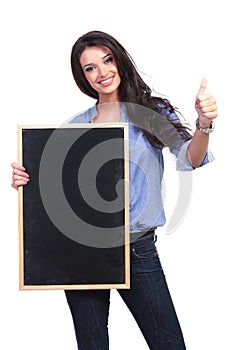 Casual woman with blackboard shows thumb up