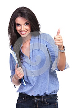 Casual woman with clipboard and thumb up