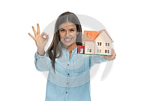 Casual woman gesturing it`s ok to invest