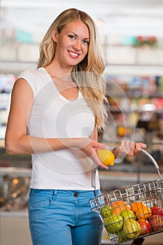 Casual woman grocery shopping at organic food section