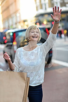 Casual woman hailing a taxi cab