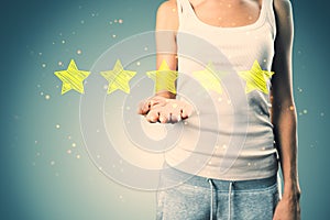 Casual woman hand holding 5 star rating on concrete wall background. Customer service and excellent feedback