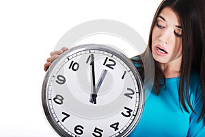 Casual woman holding a clock.