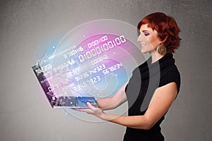 Casual woman holding laptop with exploding data and numers