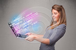 Casual woman holding laptop with exploding data and numers