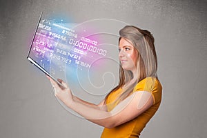 Casual woman holding laptop with exploding data and numers