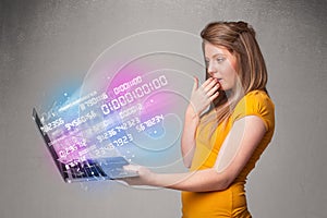 Casual woman holding laptop with exploding data and numers