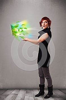 Casual woman holding notebook with recycle and environmental symbols