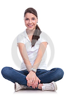 Casual woman holds crossed legs