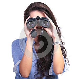 Casual woman looks at you through binoculars