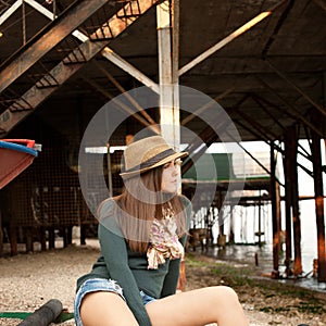 Casual woman portrait on a sea beach mooring