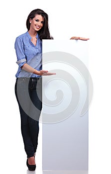 Casual woman presents a blank pannel