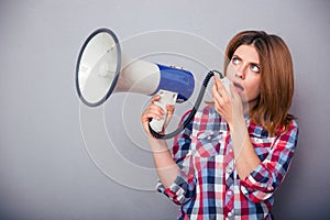 Casual woman screaming on megaphone