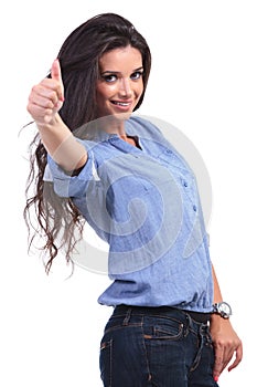 Casual woman shows thumbs up