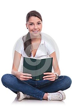 Casual woman sits with book photo