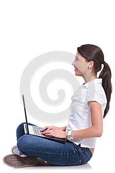 Casual woman sits with laptop