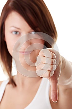 Casual woman smiling with her thumbs down