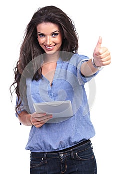 Casual woman with tablet shows thumb up