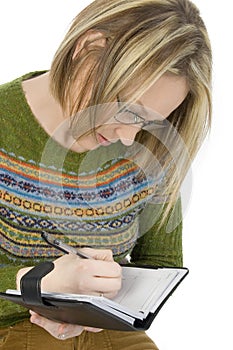 Casual Woman Writing in Datebook photo