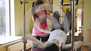 Casual women taking private pilates class with a trainer.