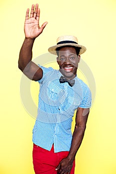 Casual young african guy posing with raised arm