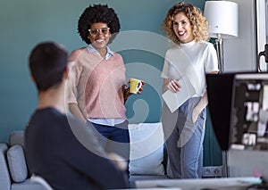 Casual young business people taking a break and talking in the new office