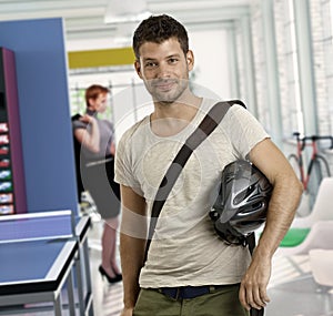 Casual young man arriving to work by bicycle photo